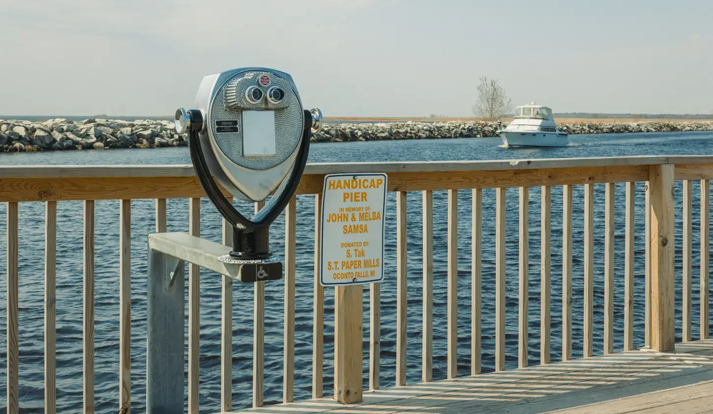 An ADA-accessible Tower Optical coin-operated binocular viewer looking across the water