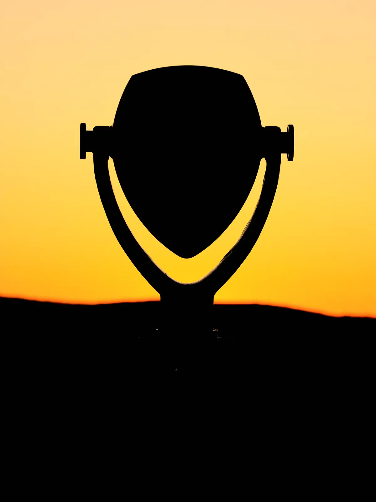 View of a Tower Optical coin-operated binocular viewer looking at a sunset